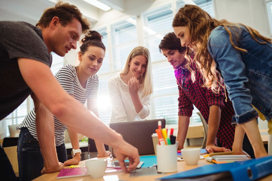 Equipo de profesionales colaborando en torno a una mesa de trabajo